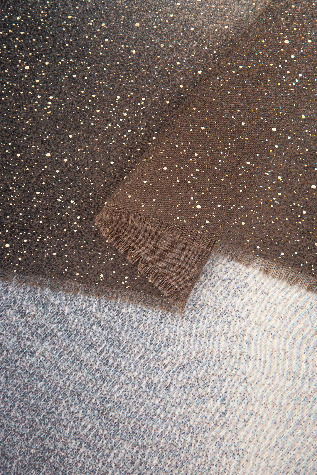 close up of the soft viscose fabric, the grey ombre and foil speckles are clearly visible.