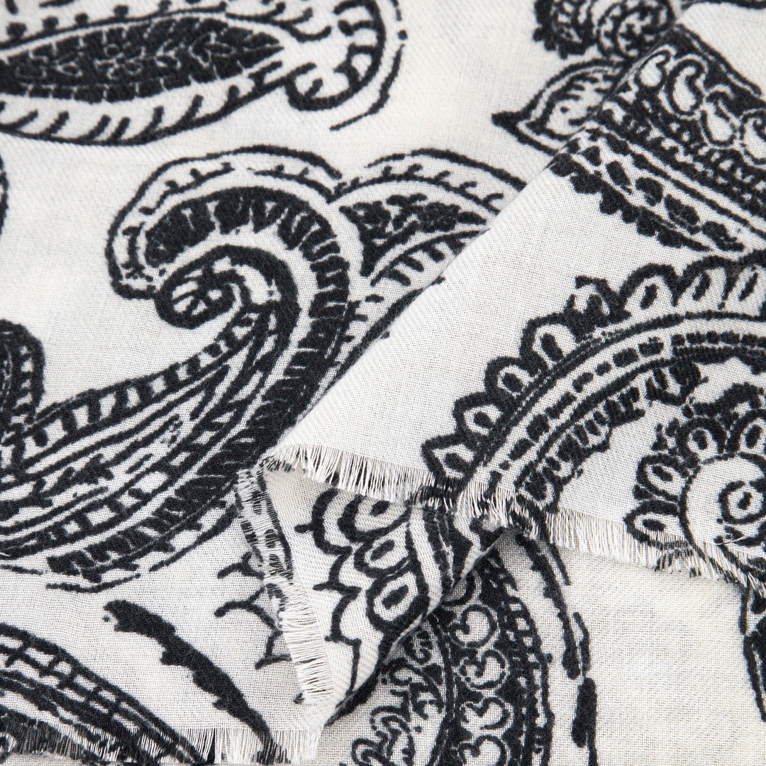 close up of the soft viscose fabric, the cream and black paisley floral design is visible