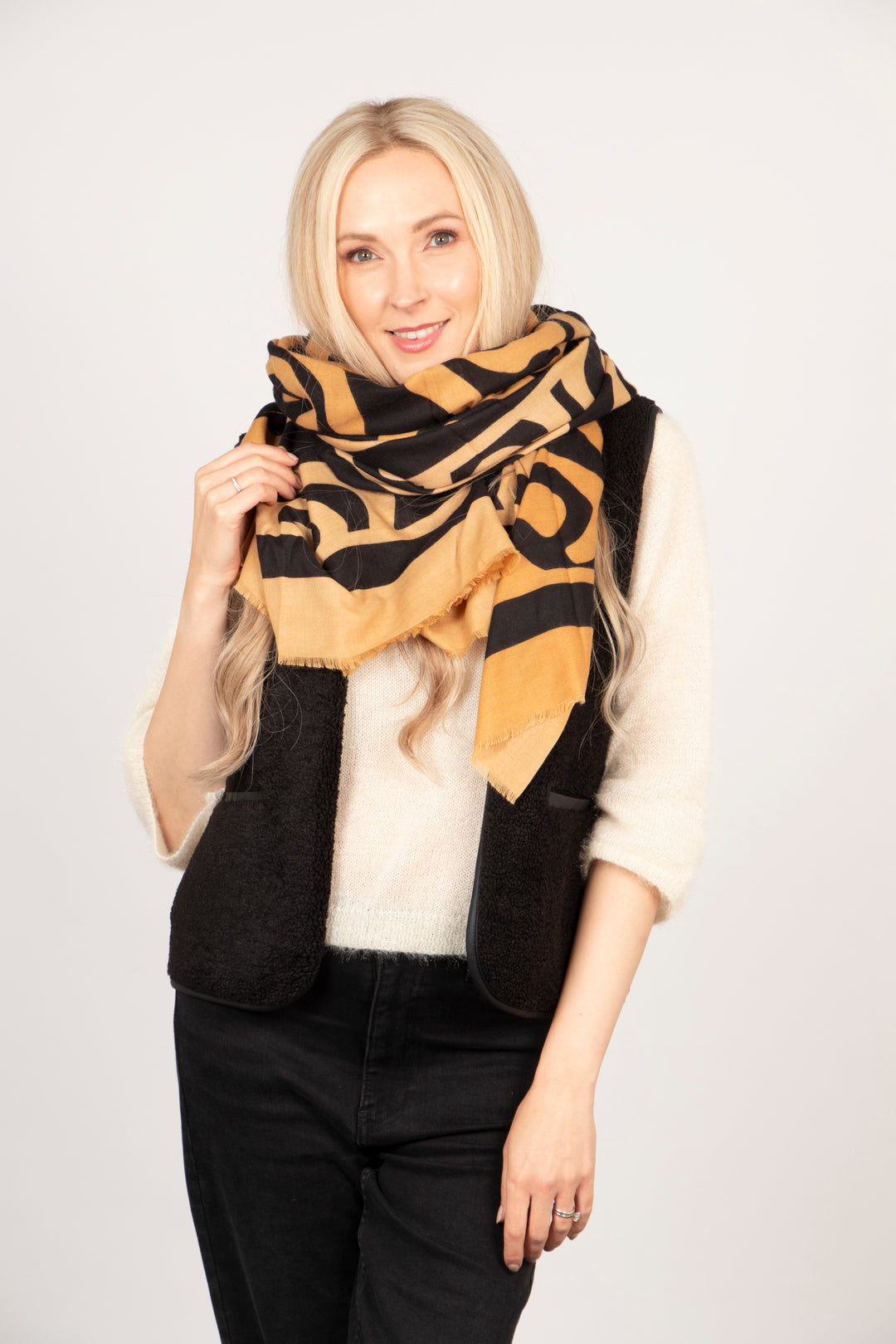 showing the scarf worn in a loose bundled wrap around the neck