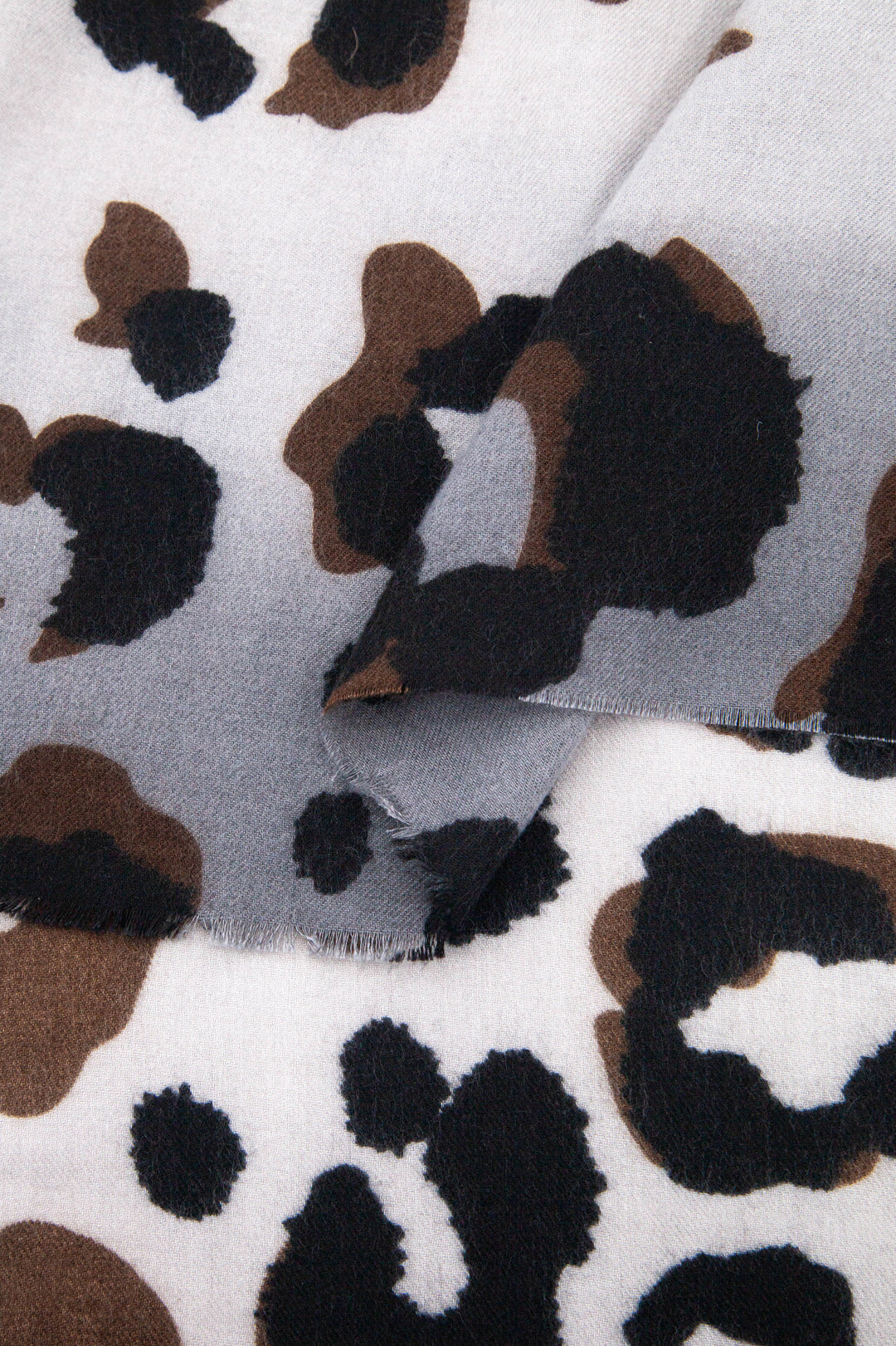 close up of the soft viscose fabric, the neutral and grey colourways are clearly visible