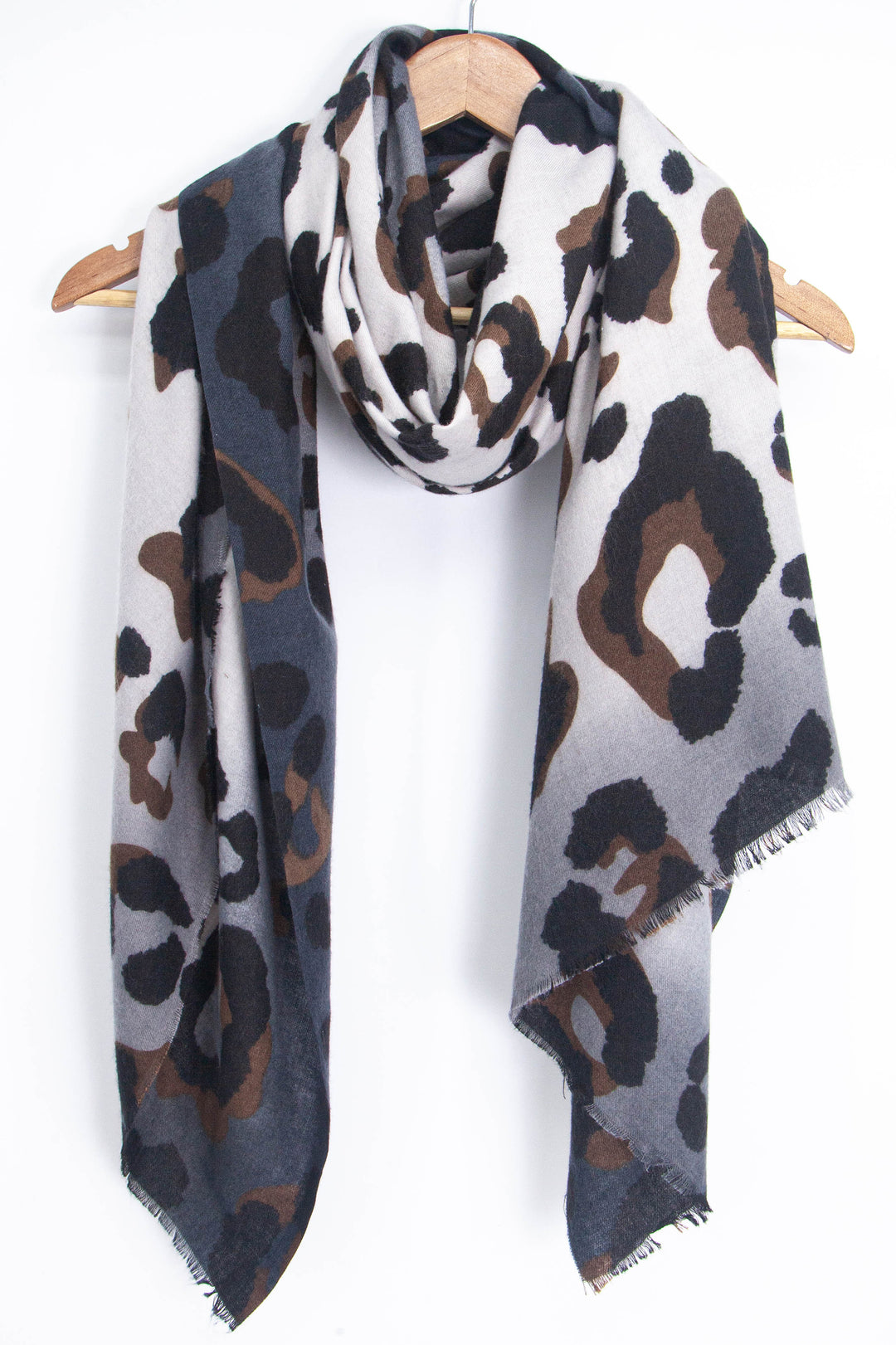 showing the grey and brown leopard print scarf draped around a coat hanger, showing how it would look when worn