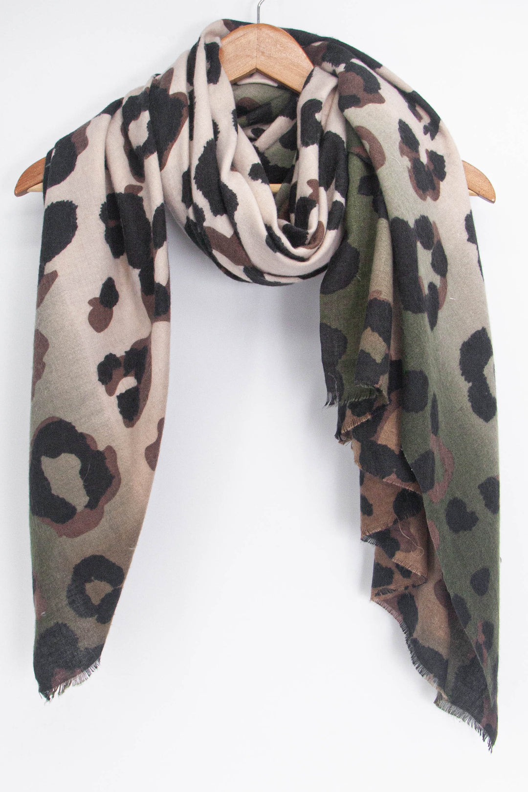 showing the khaki and beige leopard print scarf draped around a coat hanger, showing how it would look when worn