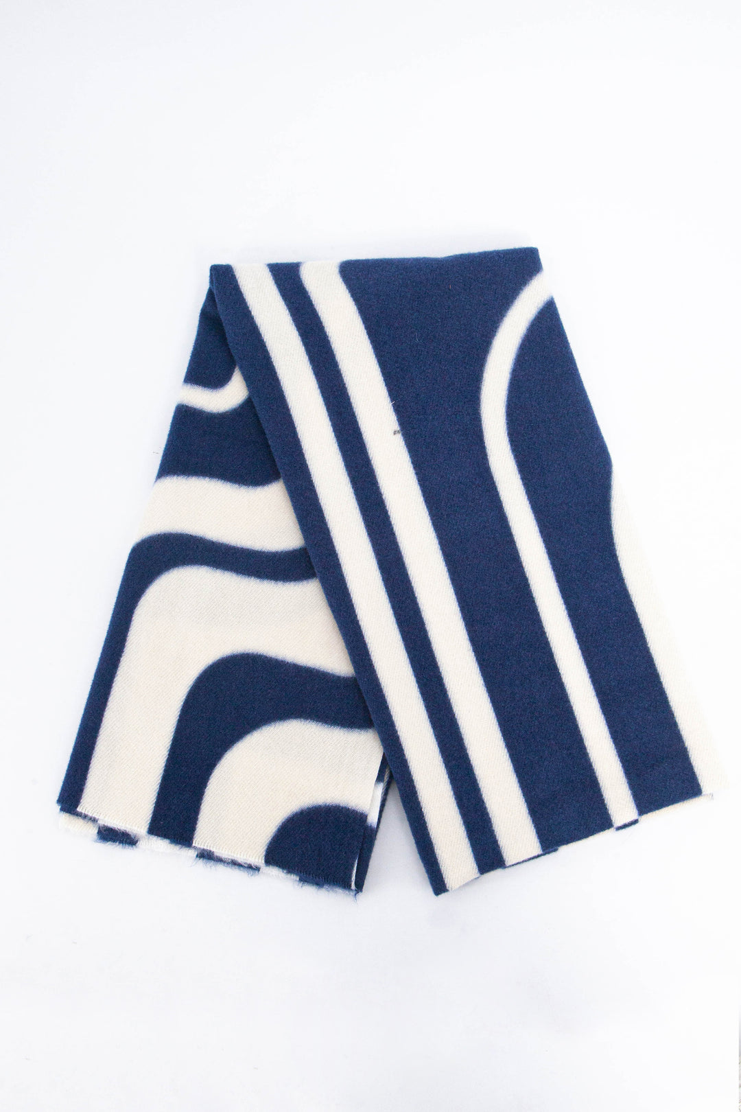 showing the scarf folded, the navy blue and cream geometric pattern is shown to cover the whole design