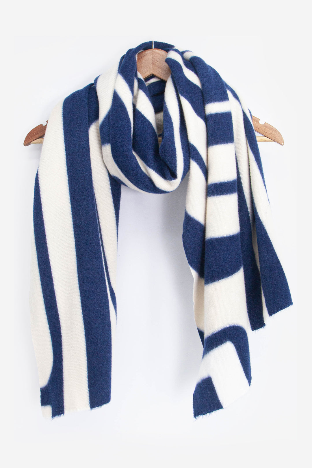 showing the scarf draped around a coat hanger, showing the all over pattern and how it would look when worn