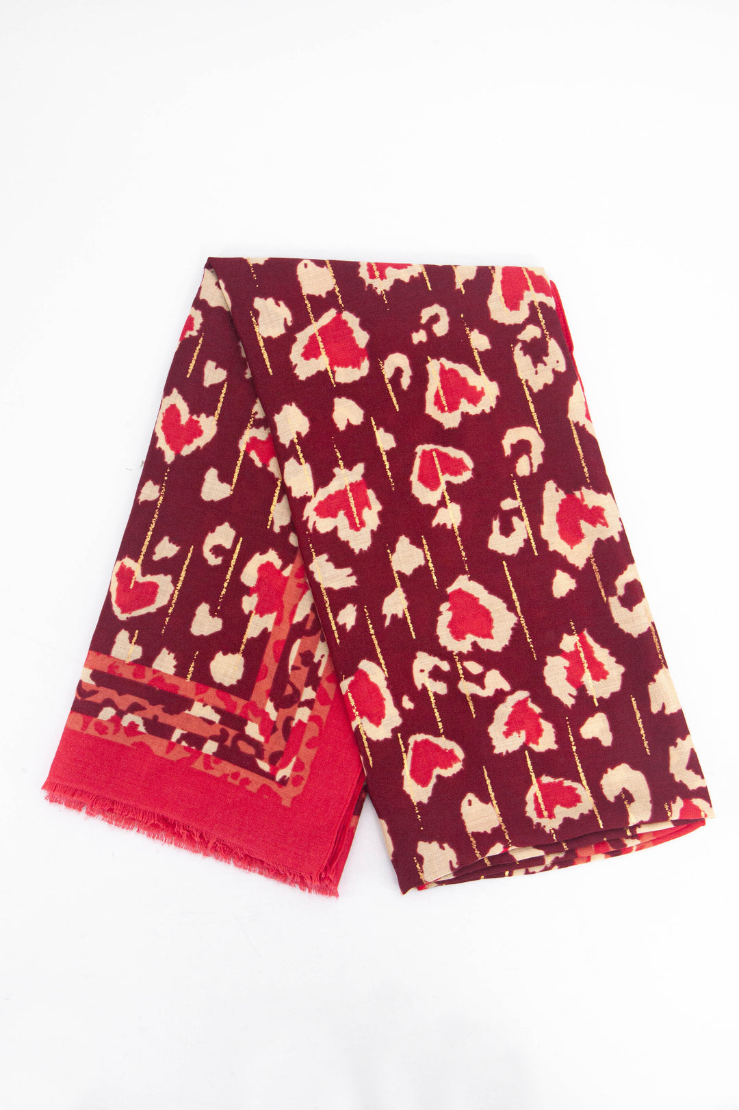 showing the scarf folded, the red leopard print pattern and gold foil pattern is shown, the scarf also has a plain red border around the outside edge of the design. 