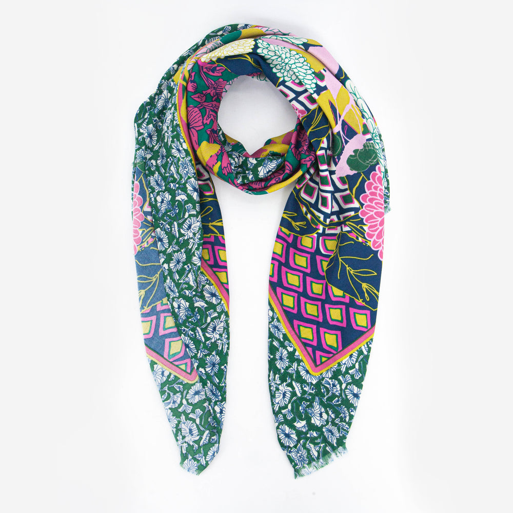 pink, yellow and blue geometric print scarf with a contrasting wide floral print border, the border is a medium green and has an ornate floral pattern.