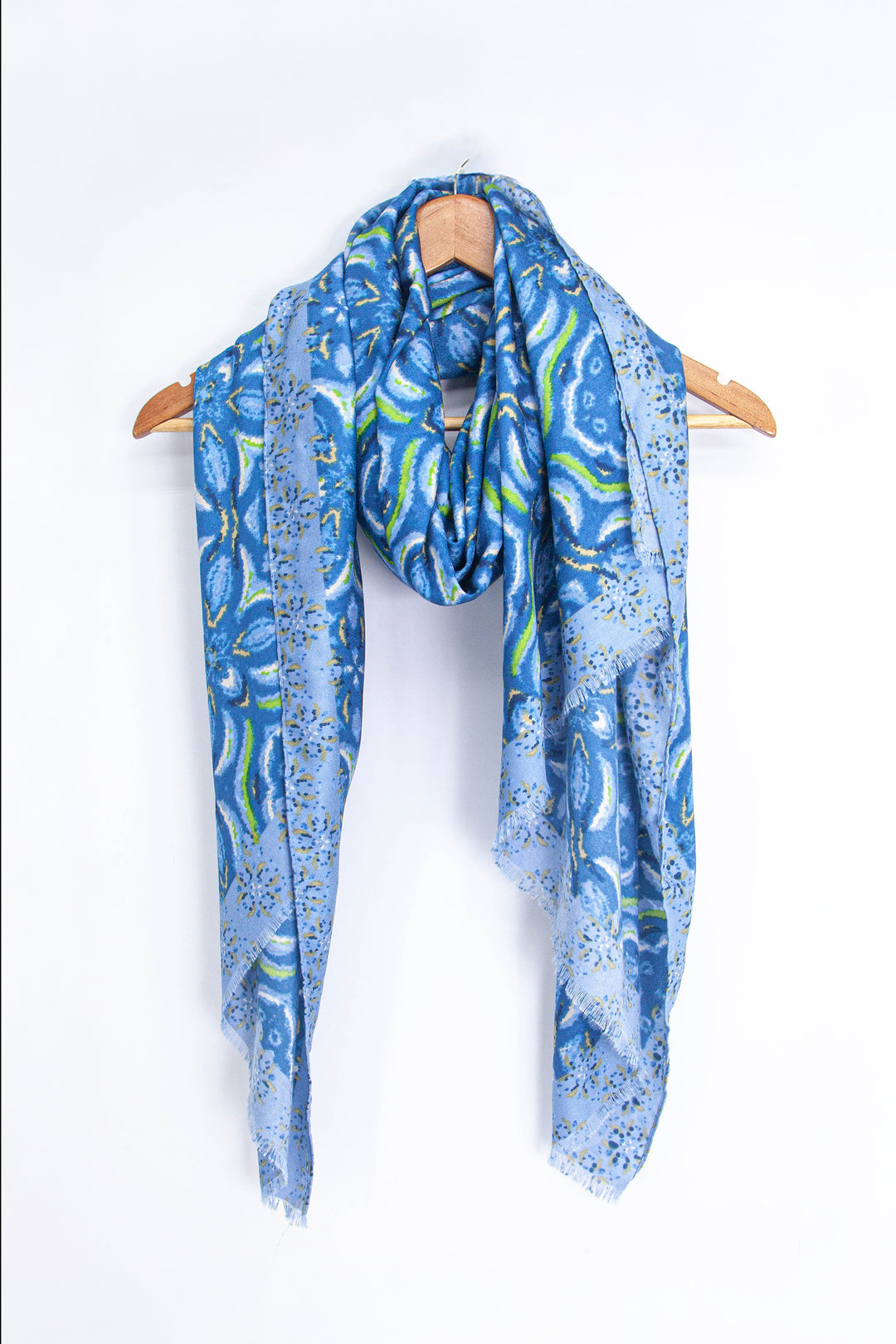 showing the scarf draped around a coat hanger, showing the all over pattern and how it would look when worn