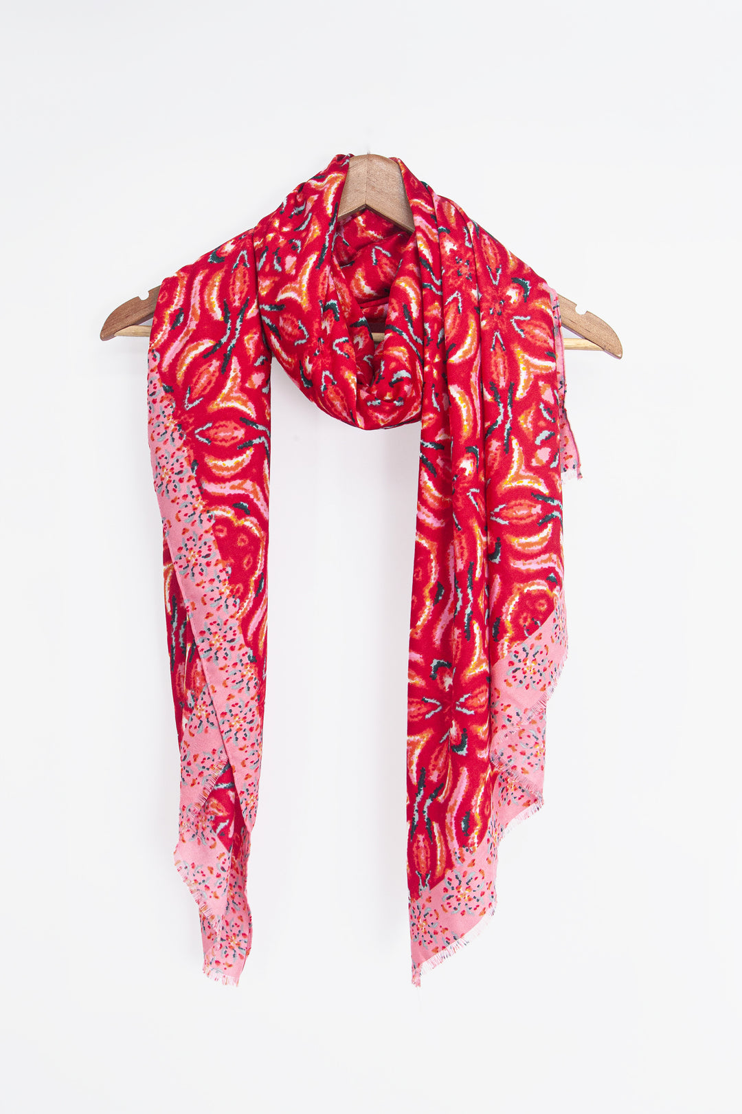 showing the scarf draped around a coat hanger, showing the all over pattern and how it would look when worn