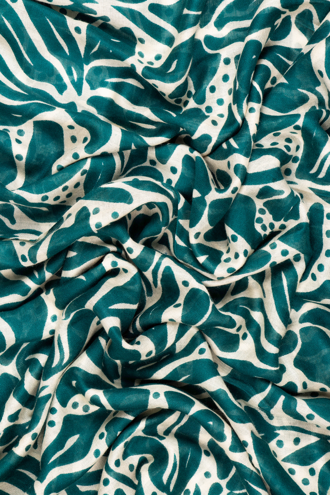 close up of the soft viscose fabric, the green and cream colourways are clearly visible