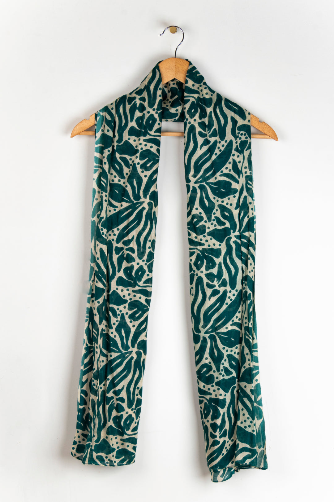 showing the scarf draped around a coat hanger, showing the all over pattern and how it would look when worn