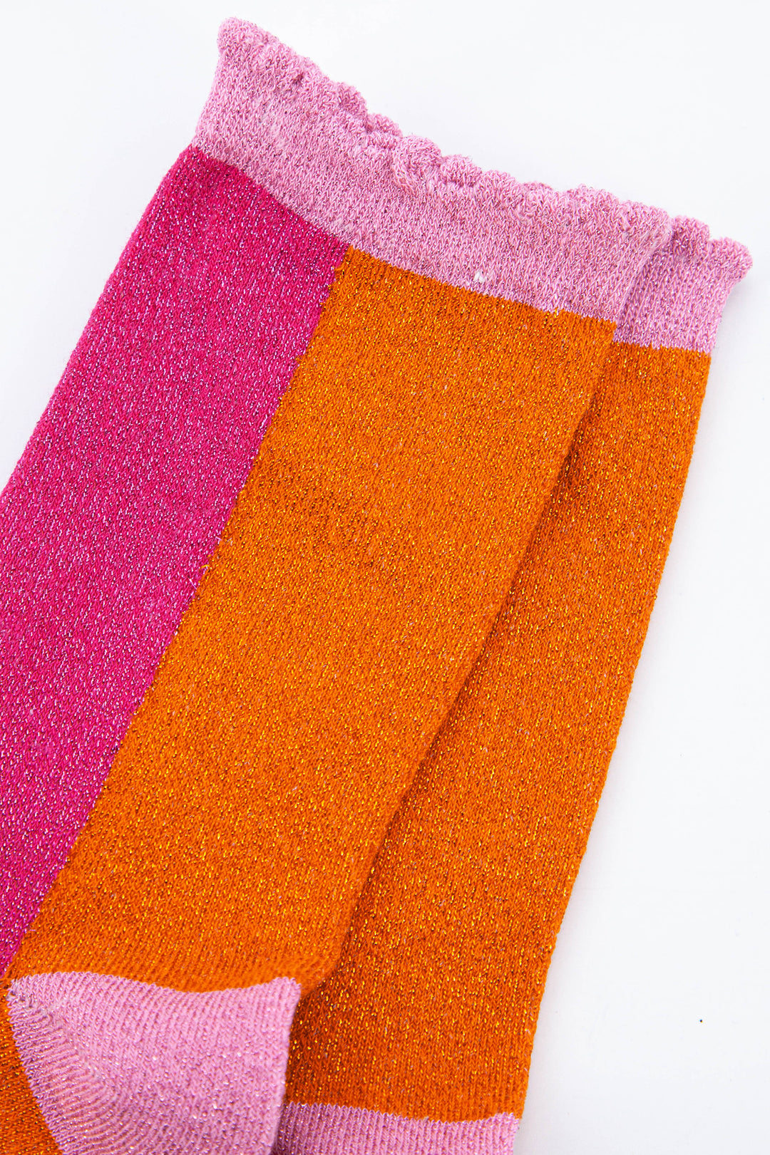 close up of the sparkly material and pink scalloped top on these ladies cotton socks