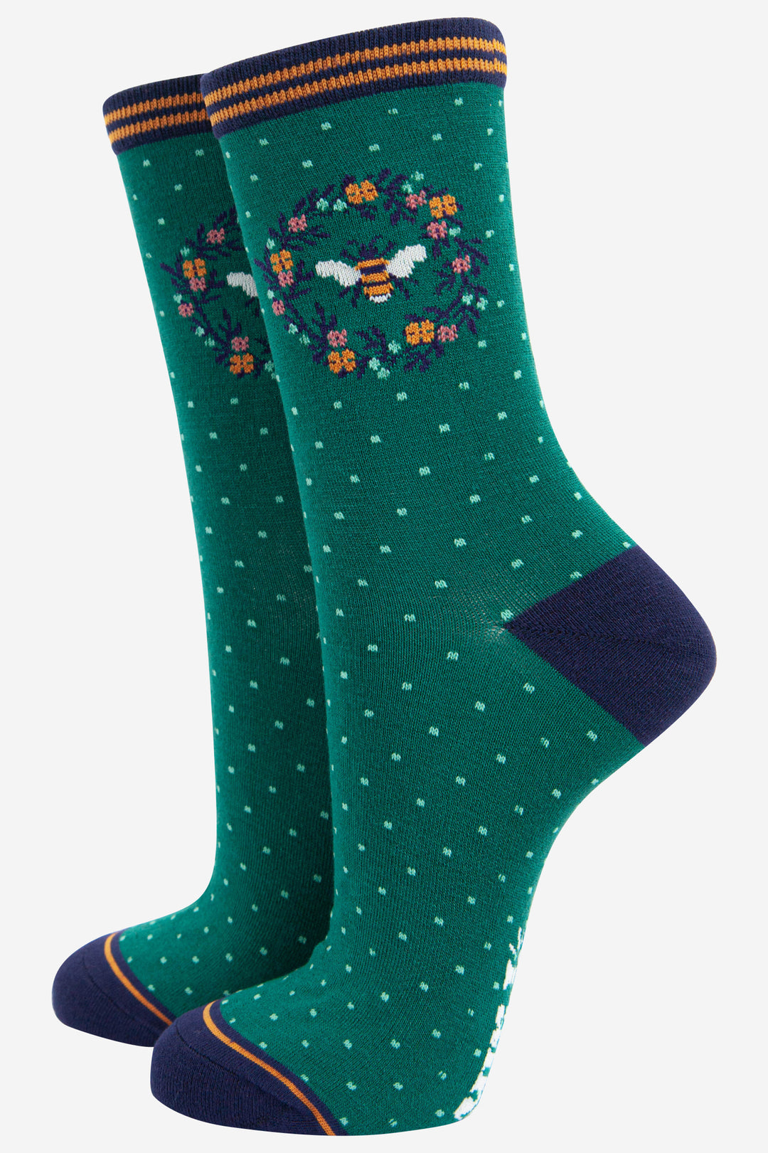 green bamboo socks featuring a large bumblebee and a floral wreath