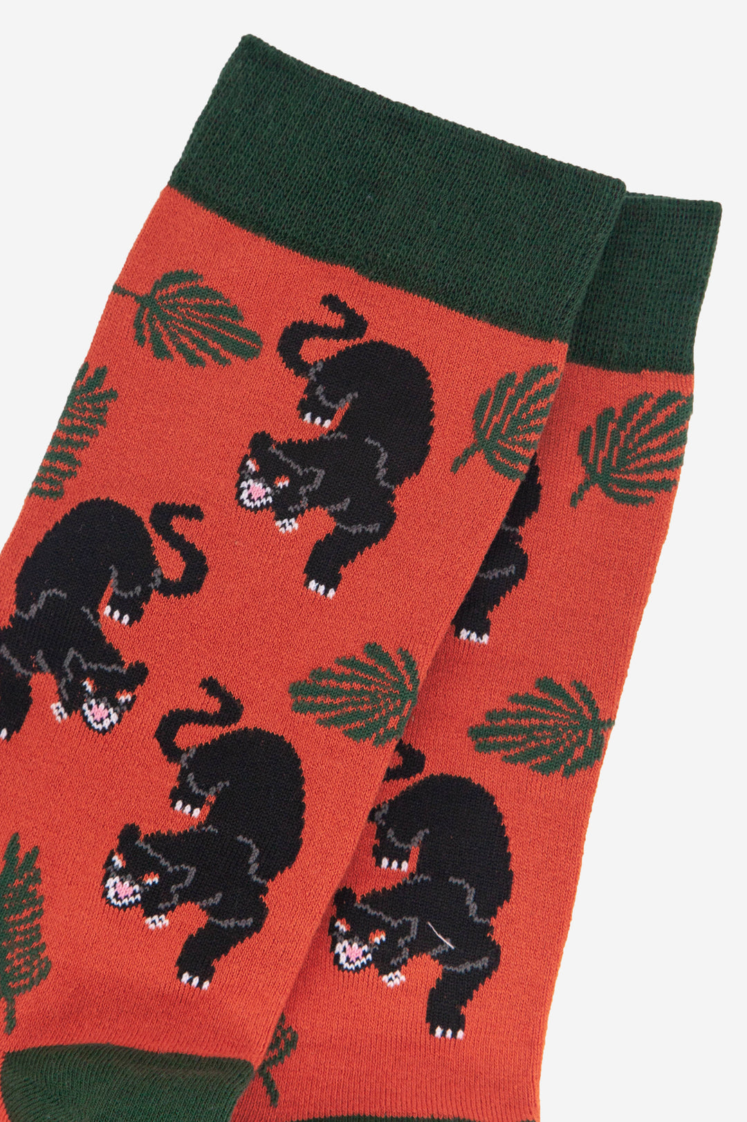 close up of the black panther and leaf print on the orange bamboo socks