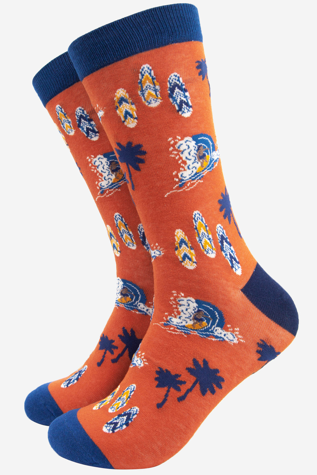 orange and blue dress socks with a pattern showing a surfer , surfboards and palm trees