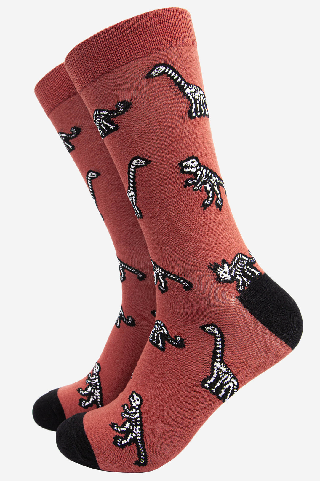 burnt orange and black dress socks featuring an all over dinosaur skeleton pattern in white