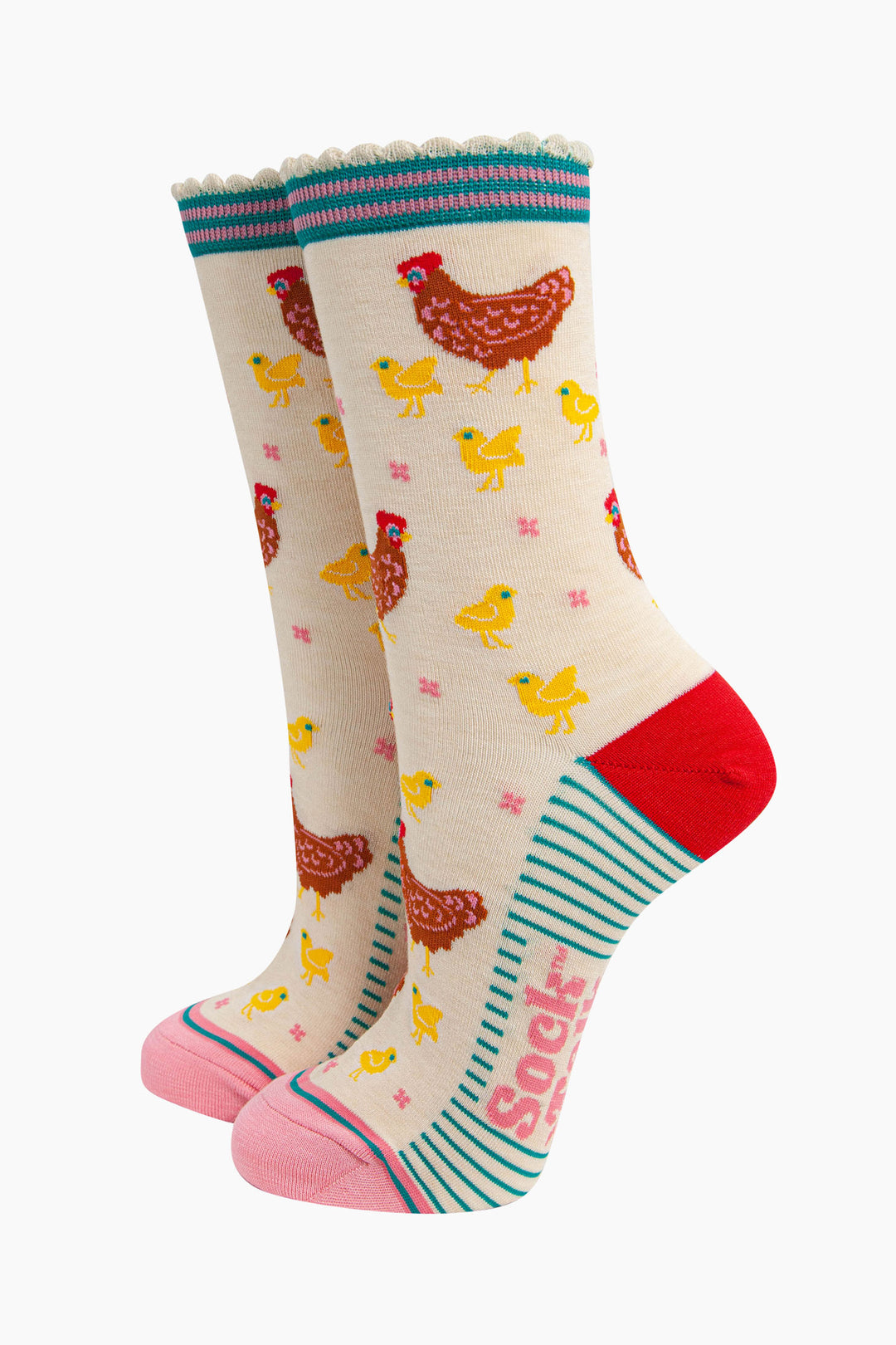 women's bamboo socks cream hen and chicks. cream bamboo socks with a pattern of brown mother hens with yellow baby chicks. the heel is red, the toe is light pink and the cuff is blue and pink striped.