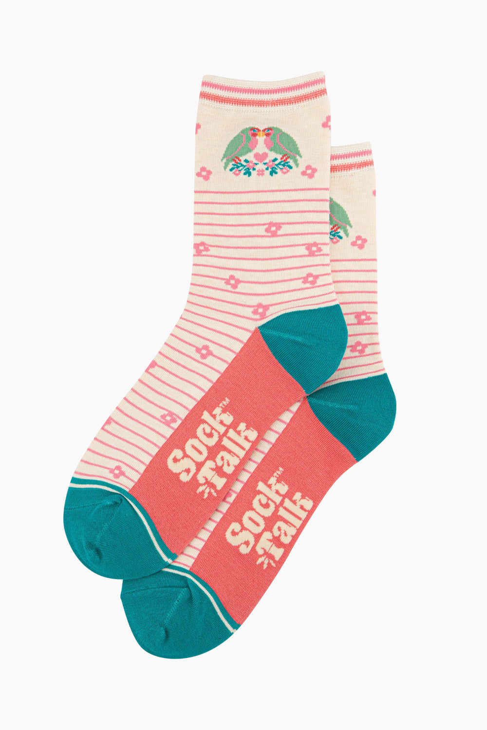 the pair of cream lovebird socks laying flat, one overlapping the other. showing clearly the cream background of the socks which is contrasted by light pink horizontal pinstripes. on the ankle there are two love birds facing each other, there is a pink love heart in the middle of them. the sock talk logo is cream visible on the base of the sole. 