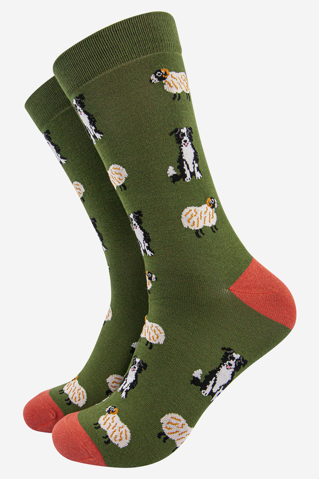 dark green socks with an orange heel and toe with an all over pattern of black and white border collie dogs and sheep