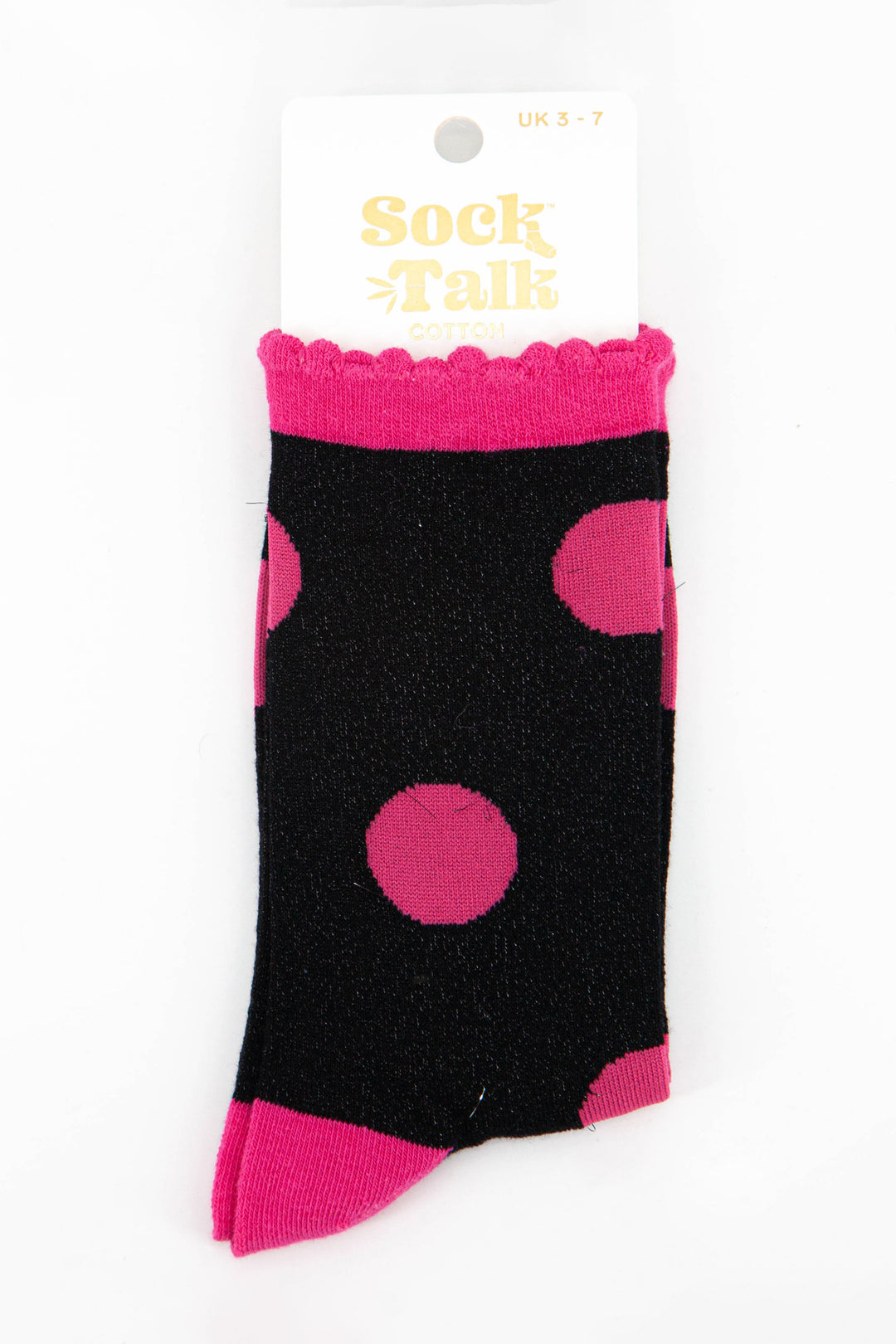 black and hot pink polka dot glitter socks in their sock talk packaging, these socks are a uk size 3-7