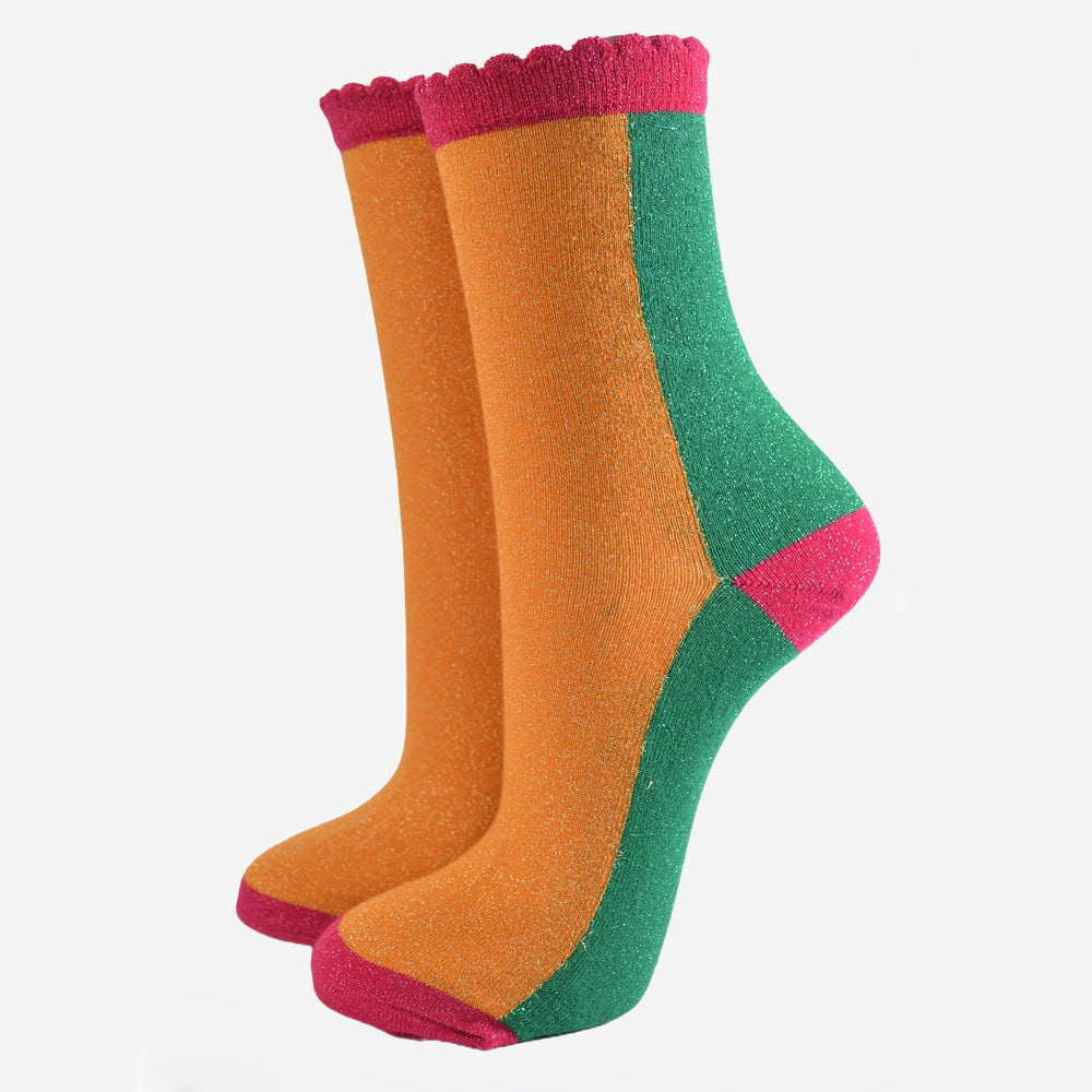 orange and green colour block socks with pink heel, toe and cuff with an all over glitter sparkle and scalloped edge