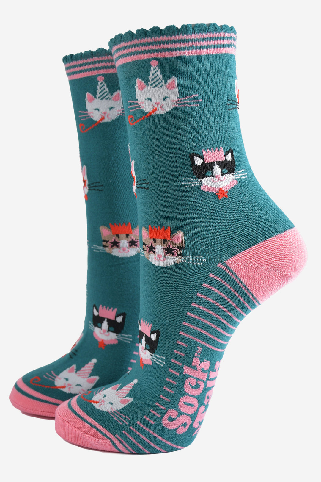 teal green socks with pink heel, toe and striped cuff with an all over pattern featuring cats wearing party hats