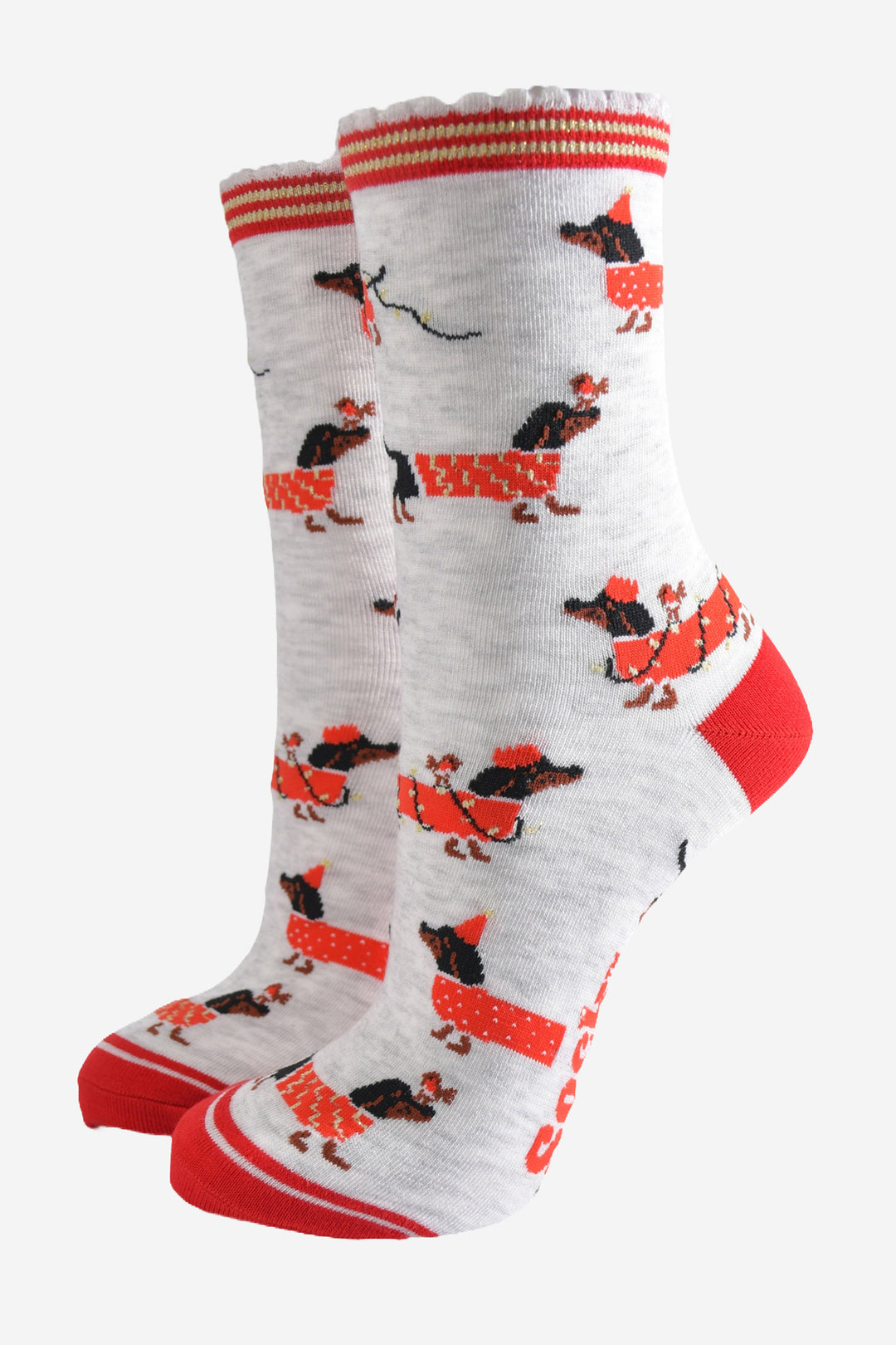 light grey socks with a red heel, toe and cuff with a  pattern of dachshunds wearing xmas lights, jumpers and playing with red robin birds