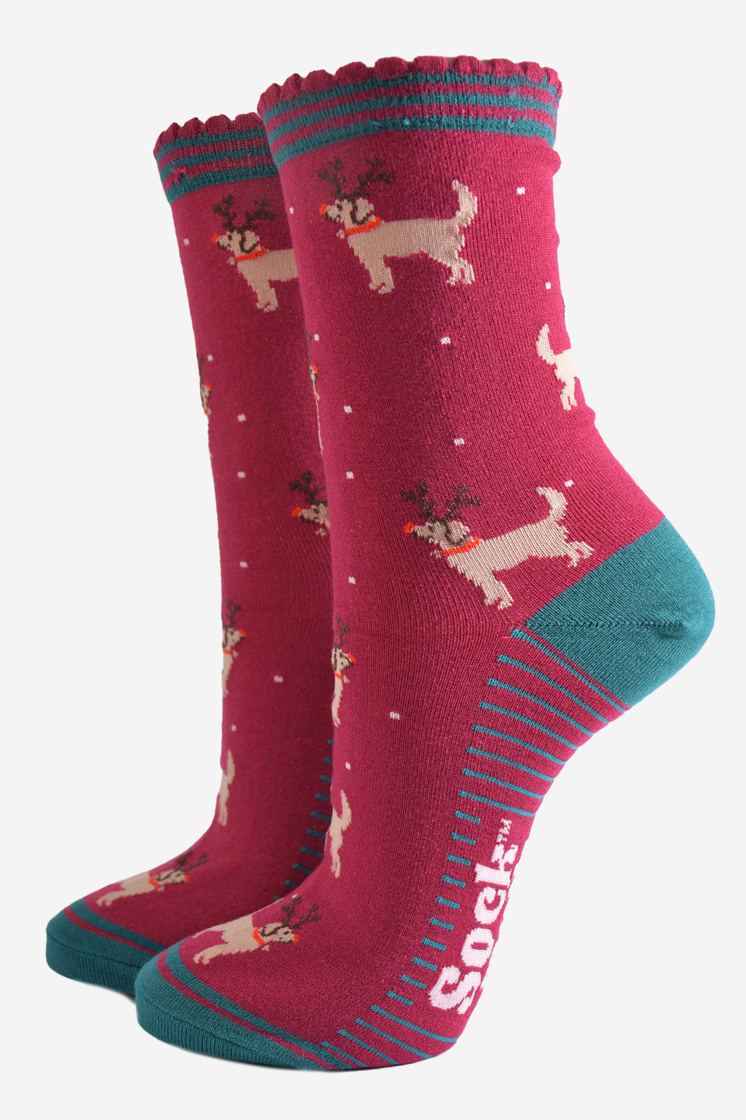 berry red socks with a pattern of golden retriever dogs wearing xmas reindeer antlers