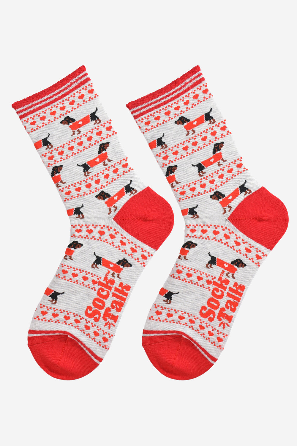 showing the sausage dog fair isle socks laying flat showing the all over pattern on the socks. the socks have a light grey background and contrasting red heel and toe