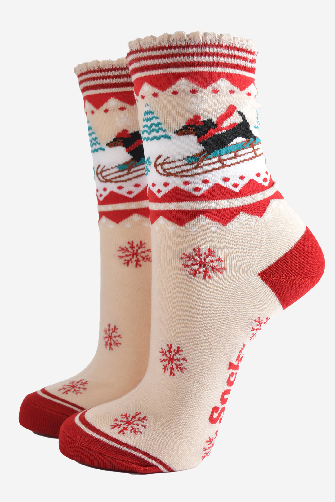 cream and red bamboo socks featuring a sledging sausage dog and red snowflake pattern