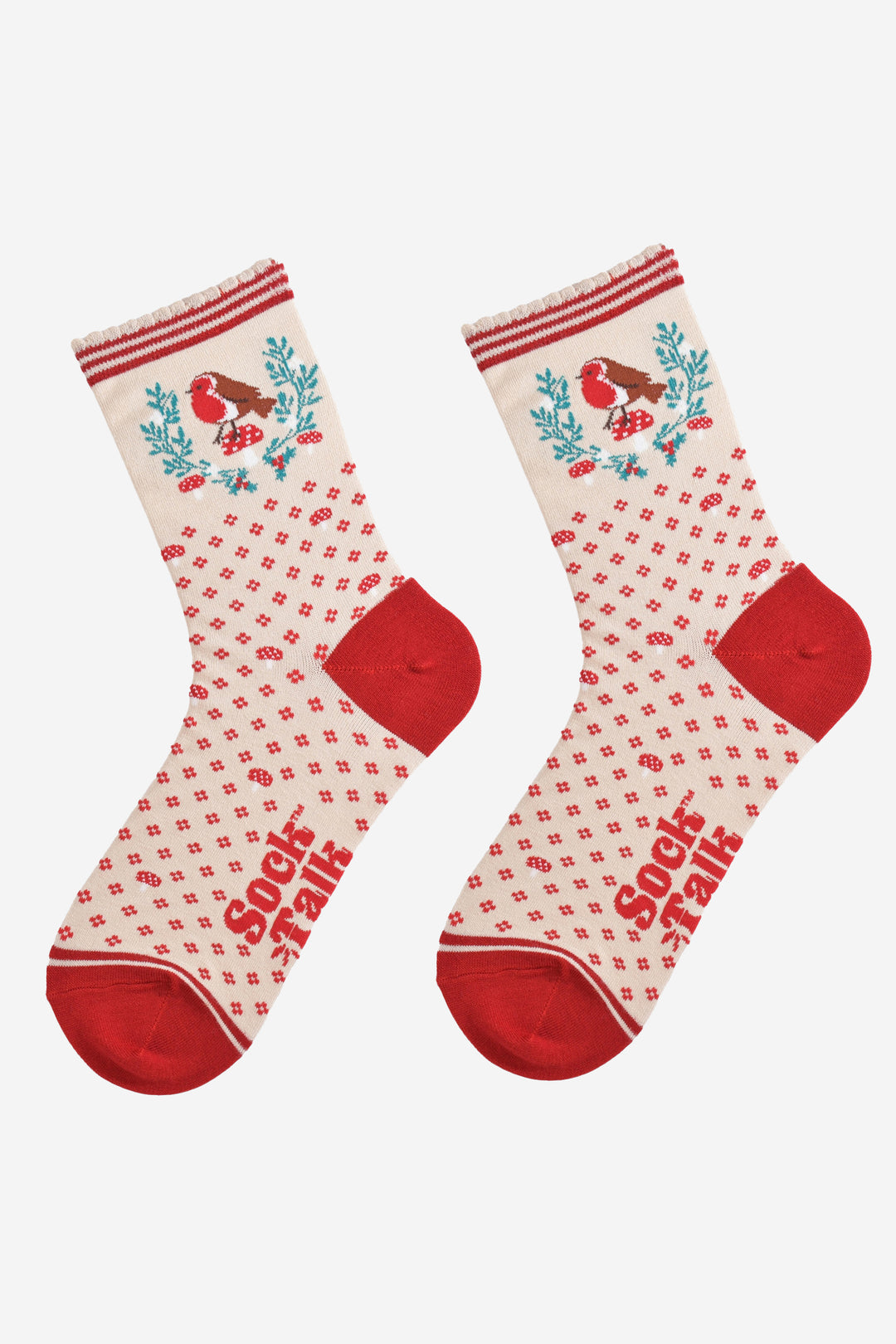 showing the cream and red robin socks laying flat, there is a floral and toadstool pattern on the body of the socks on the ankle of the socks there is a large green wreath with a red robin sitting on a toadstool 