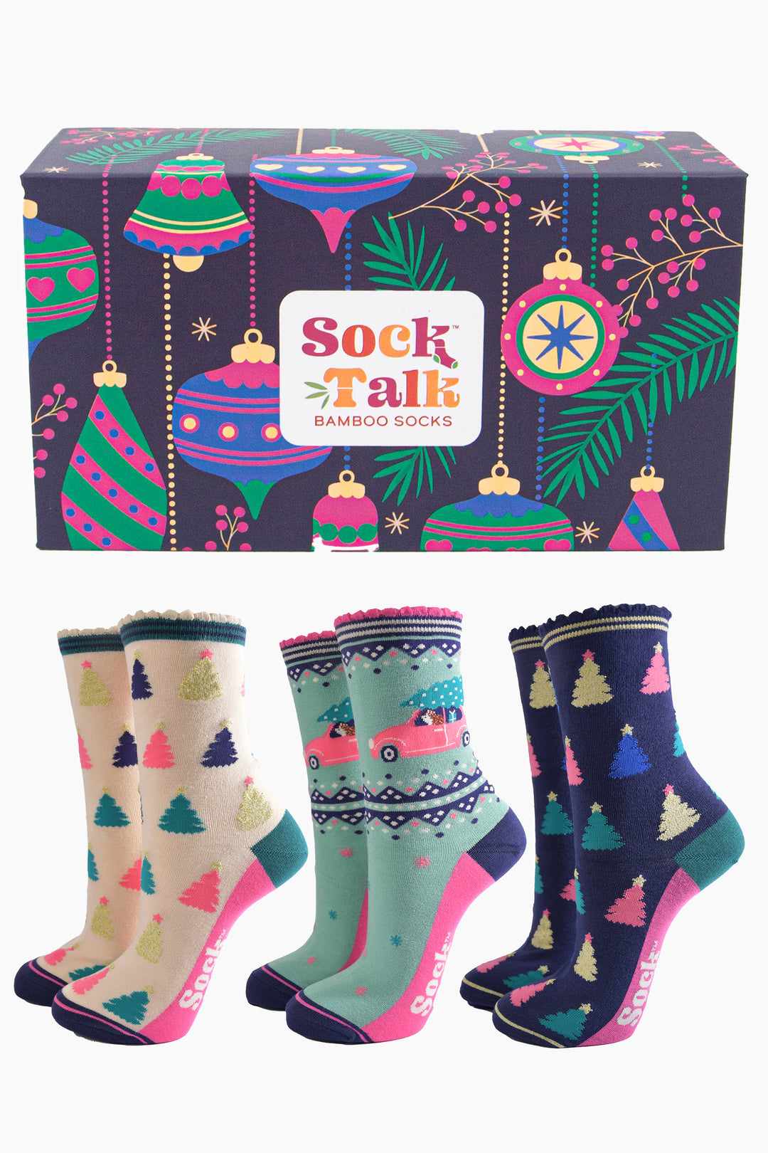 three pairs of festive bamboo socks, two with multicoloured xmas trees and one featuring a hedgehog driving a pink sports car with a christmas tree on  the roof. all three pairs of socks are contained in an artistically designed christmas bauble pattern gift box