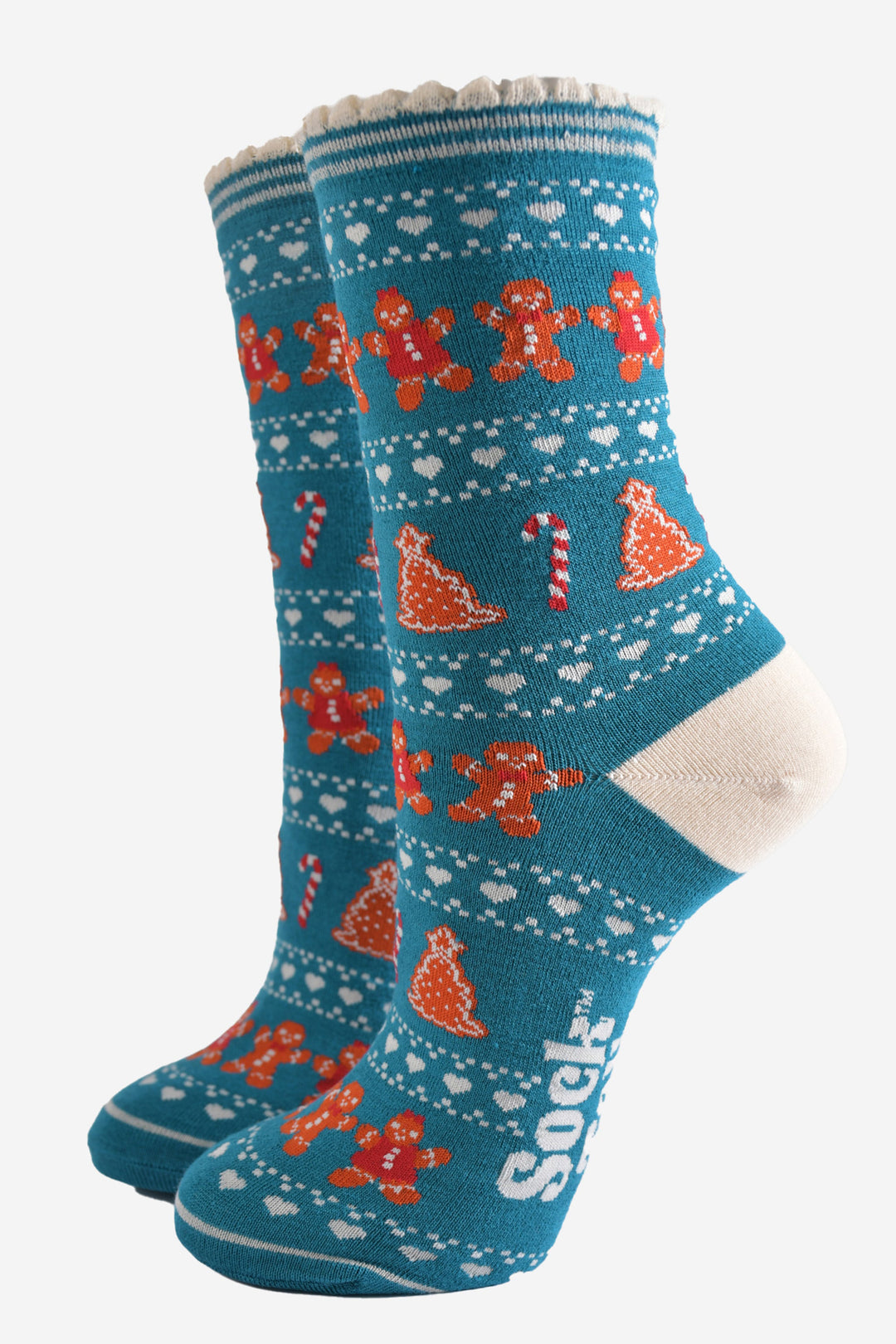 teal blue bamboo socks with a fair isle style pattern featuring candy canes, gingerbread cookies and love hearts