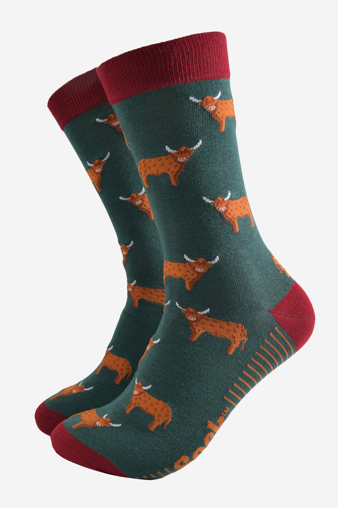 green dress socks with a red heel, toe and cuff with an all over pattern of orange standing highland cows