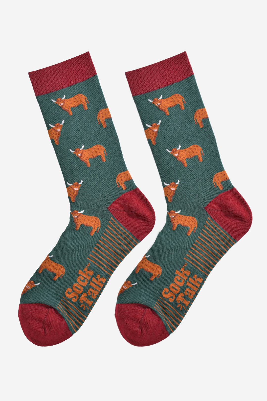 green and red highland cow bamboo socks laying flat, the highland cows are shown in profile and they are standing up