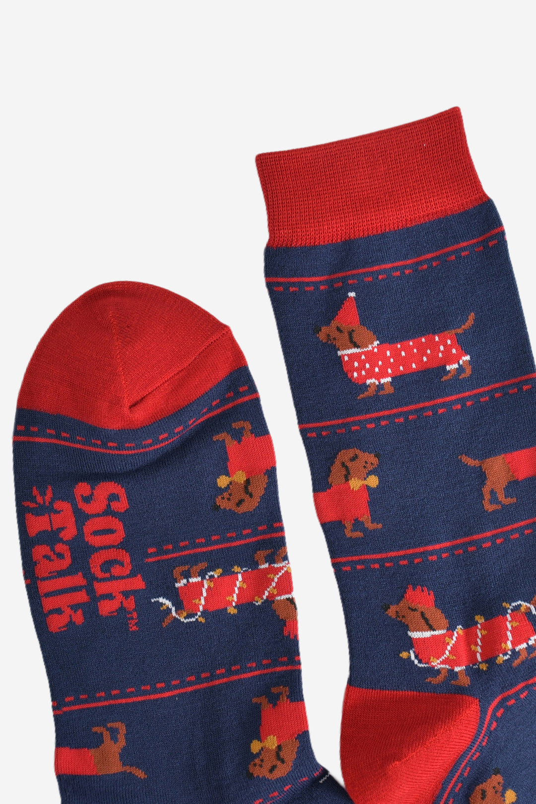 close up of the toe and cuff of the socks, these are red in keeping with the festive party clothing the sausage dogs are wearing, the rest of the socks are navy blue