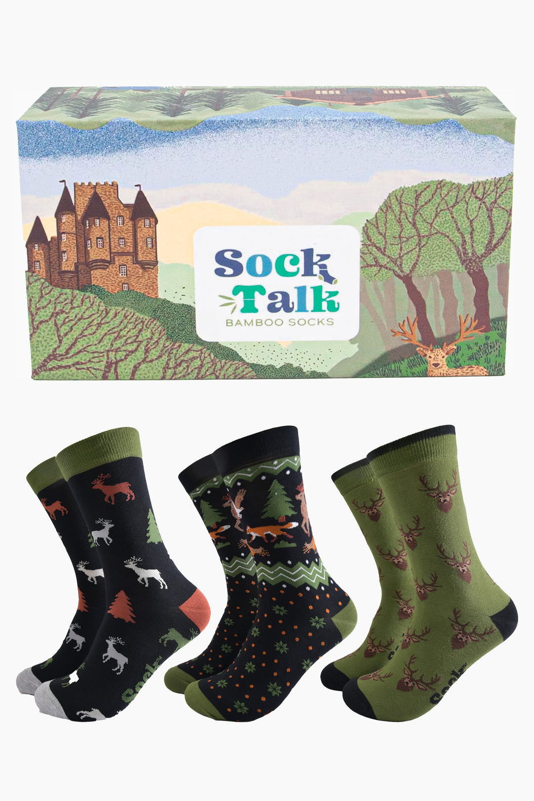 three pairs of woodland animal bamboo dress socks in a gift box designed to look like the scottish highlands. the box has a castle, stag and forest