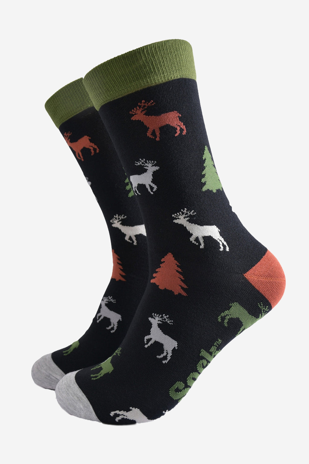 black crew socks with green cuff, grey toe and orange heel with a pattern of stags and christmas trees all over