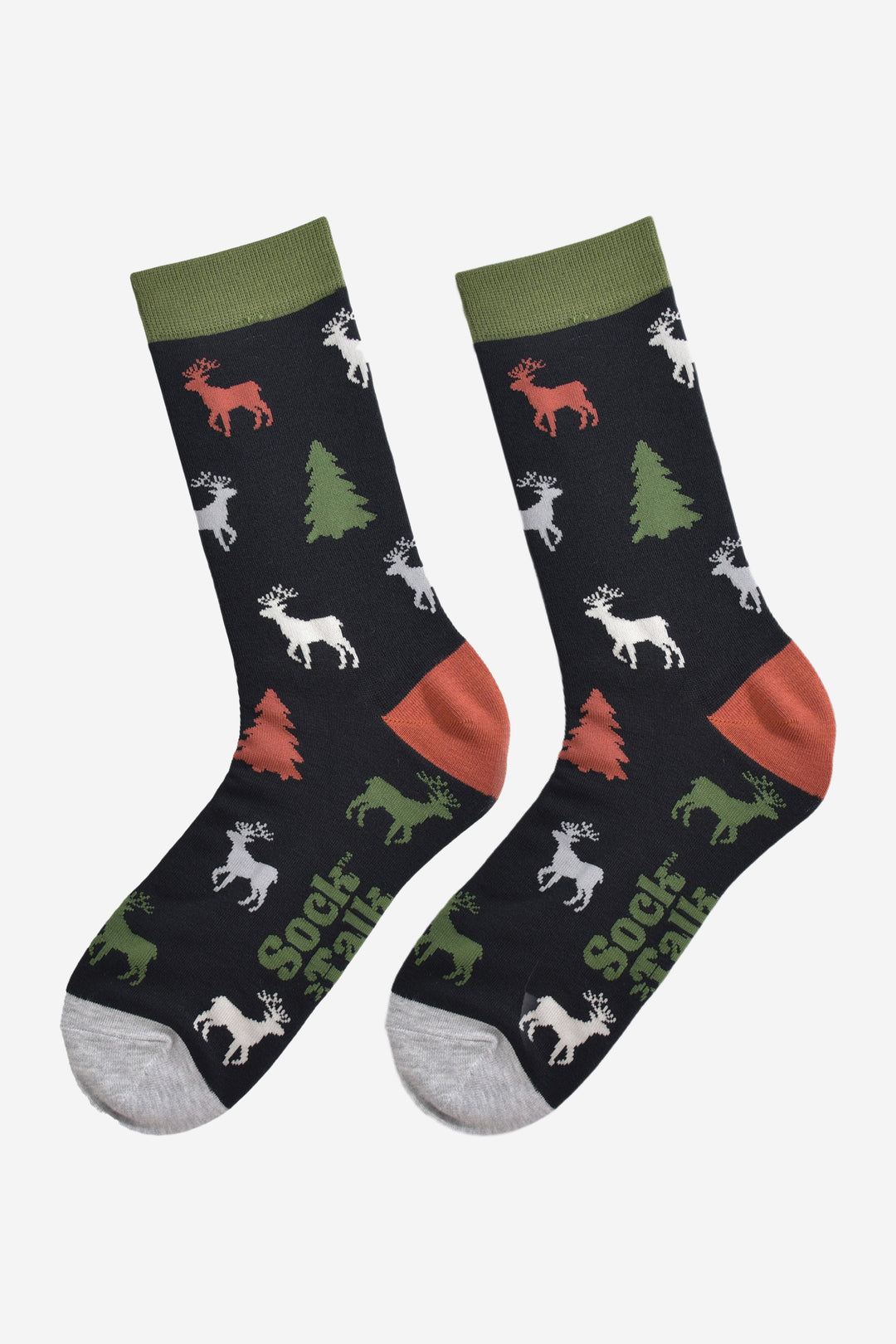 showing the stag and christmas tree socks laying flat, the reindeer are orange, green, grey and white, the trees are green and orange all on a black back ground