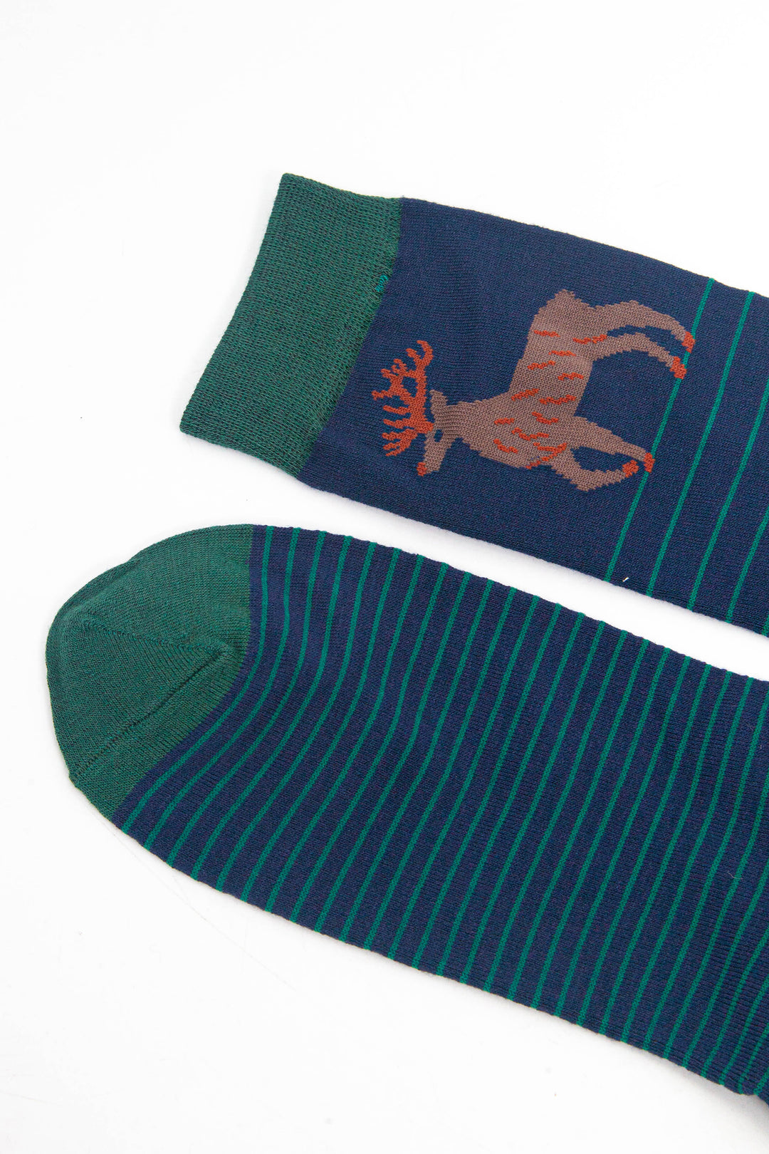 close up of the toe and cuff, both are green in contrast to the navy blue base of the socks