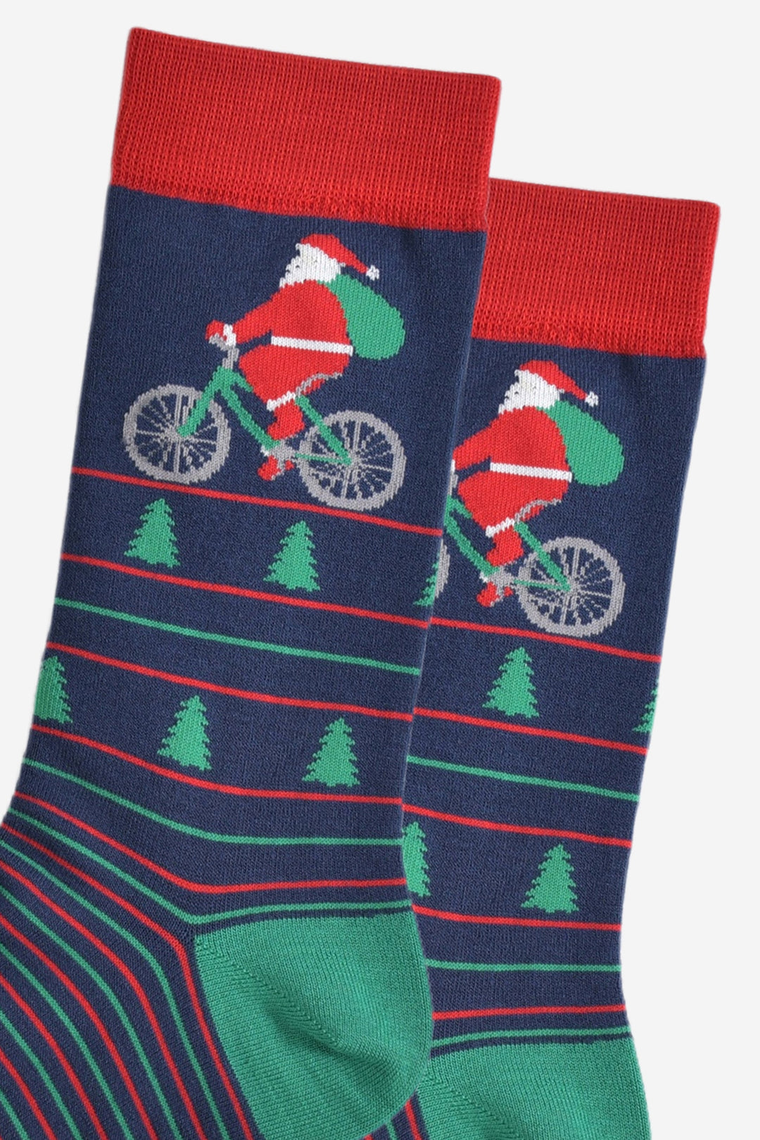 close up of santa claus on the bicycle, his bike is green and he is carrying a green sack of presents