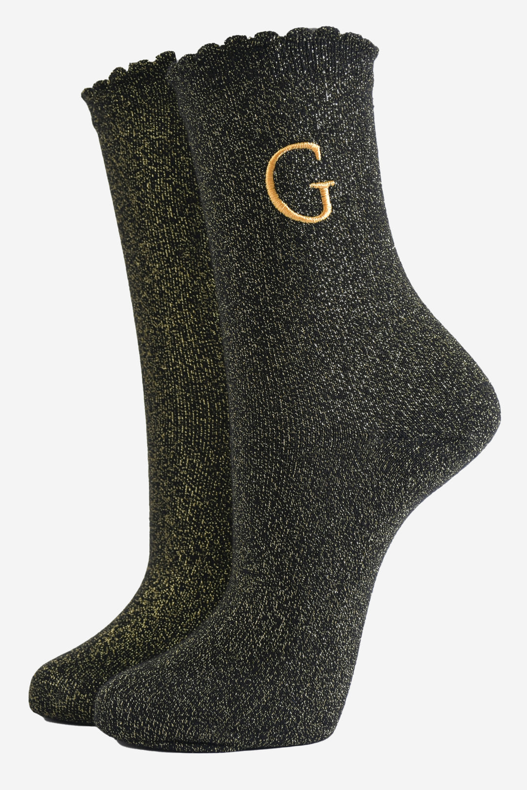 black ankle socks with a scalloped cuff, with an all over gold glitter sparkle and an embroidered gold letter g on the ankle