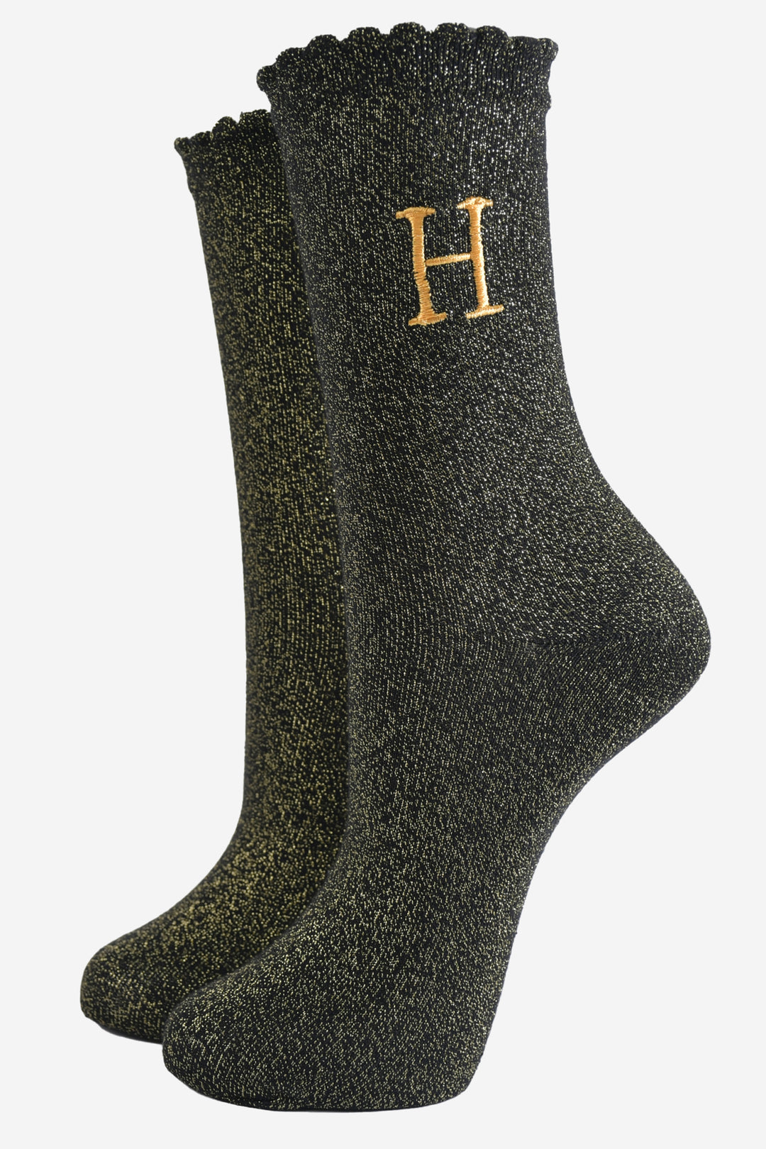 black ankle socks with a scalloped cuff, with an all over gold glitter sparkle and an embroidered gold letter h on the ankle