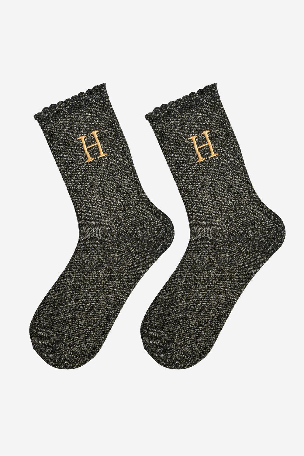 showing the glitter socks laying flat, they have a scalloped cuff and an all over gold sparkle