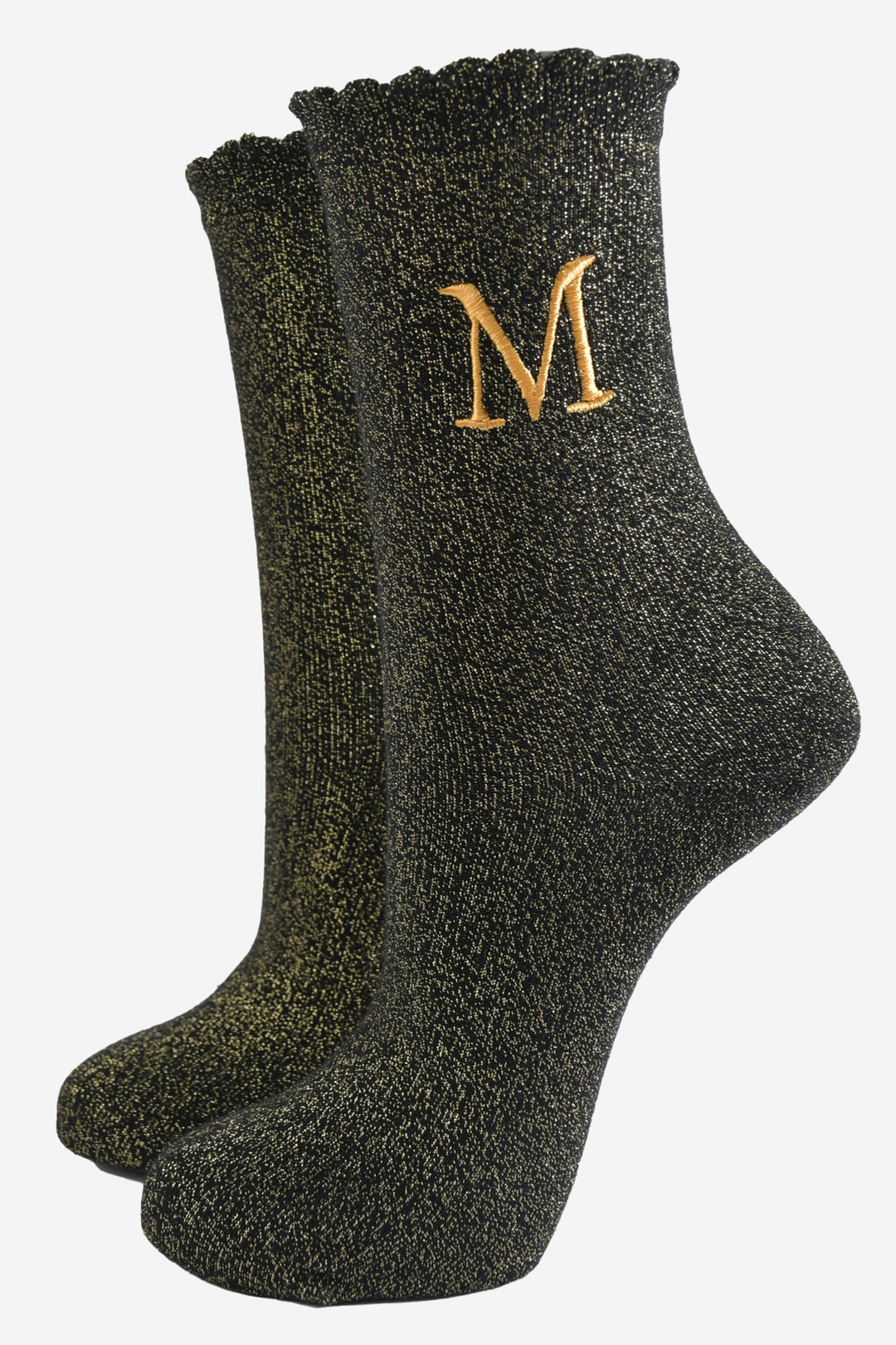 black ankle socks with a scalloped cuff, with an all over gold glitter sparkle and an embroidered gold letter m on the ankle