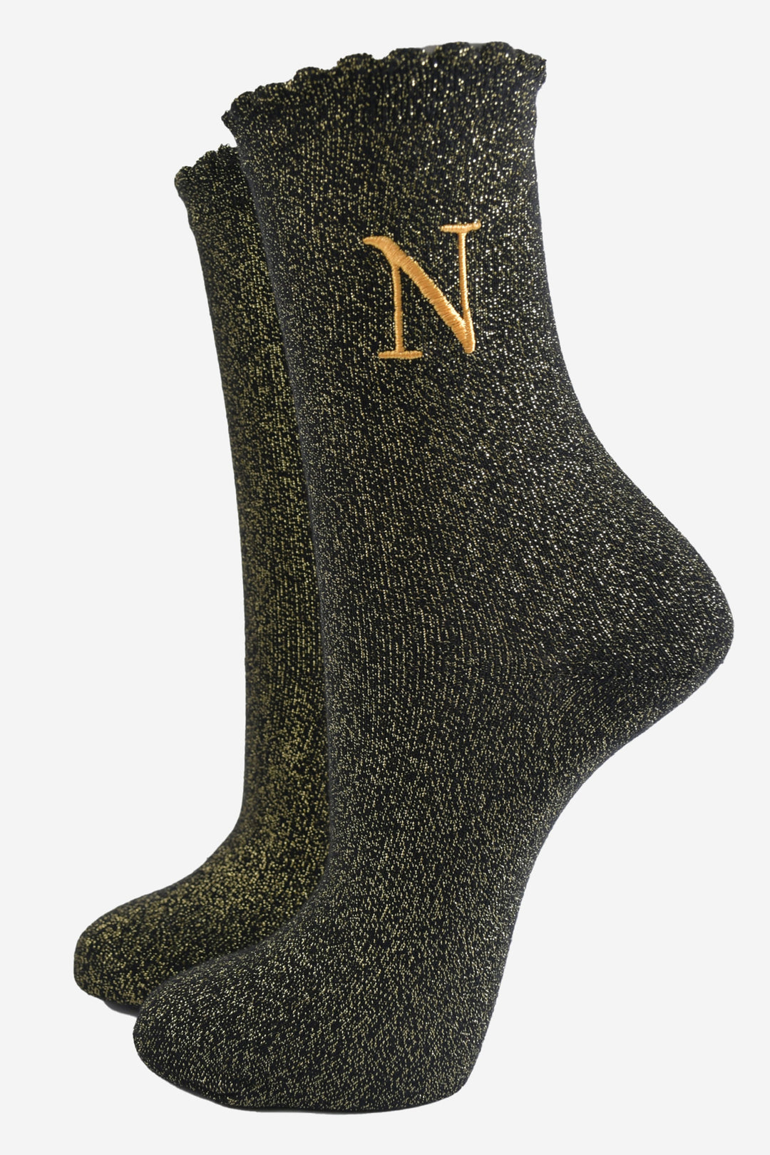 black ankle socks with a scalloped cuff, with an all over gold glitter sparkle and an embroidered gold letter n on the ankle