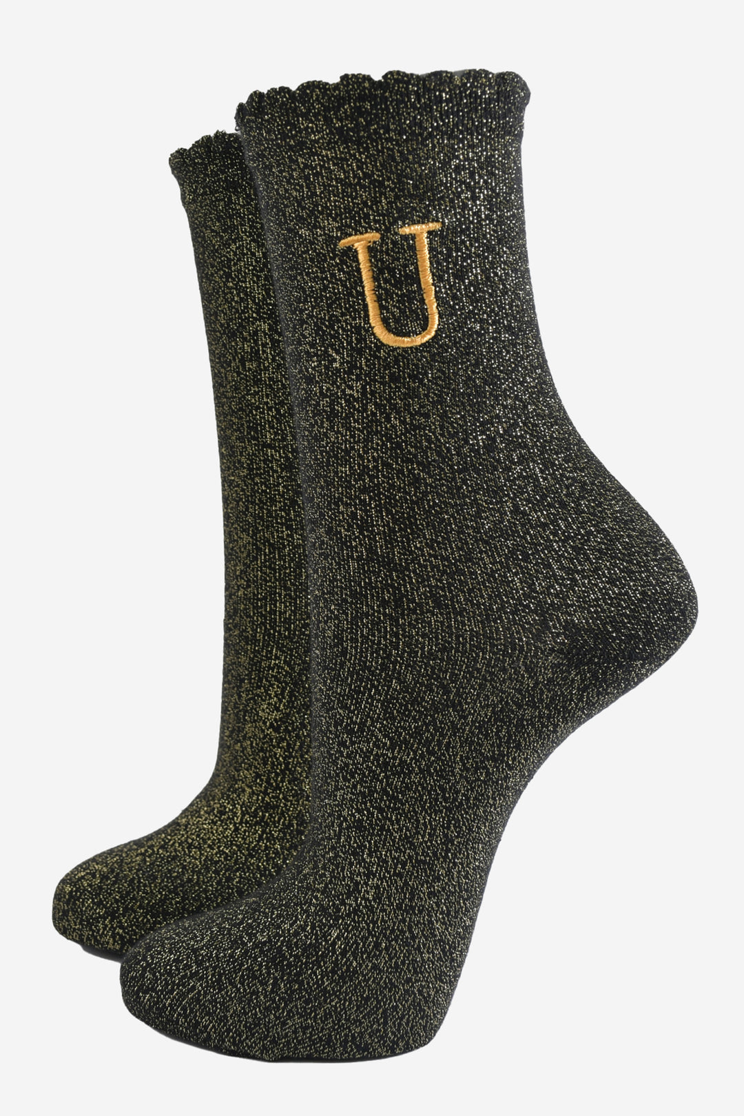 black ankle socks with a scalloped cuff, with an all over gold glitter sparkle and an embroidered gold letter u on the ankle