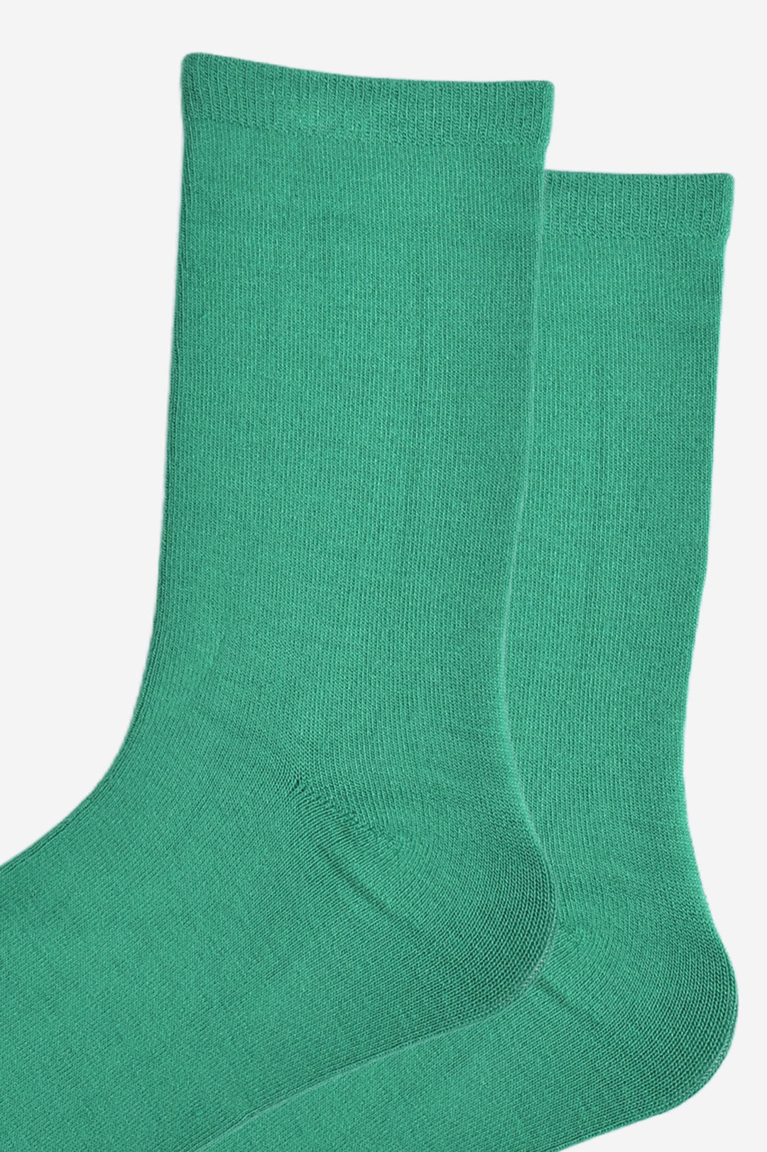 close up of the socks, showing the plain green colour and the classic straight cuff