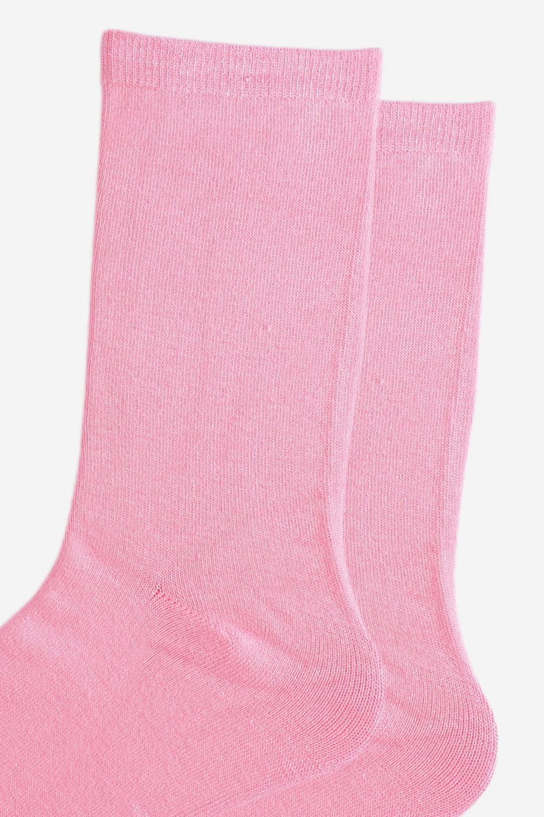 close up of the socks, showing the plain pink colour and the classic straight cuff