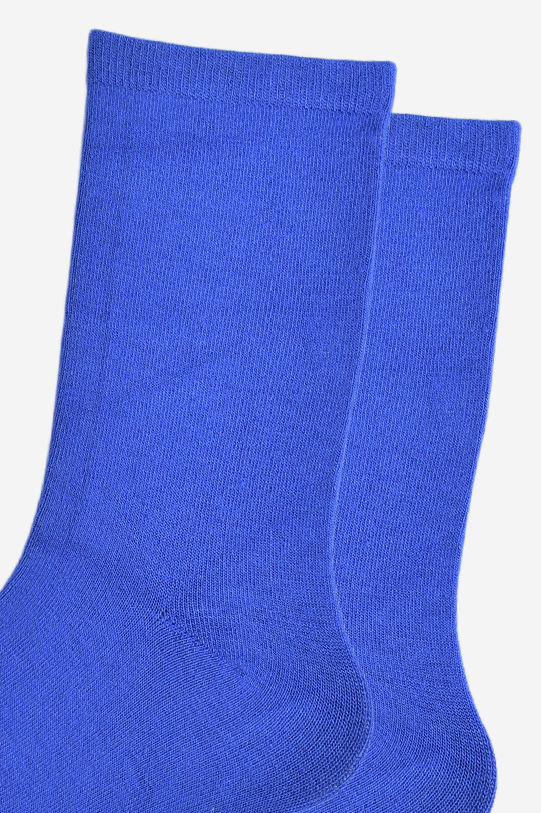 close up of the socks, showing the plain royal blue colour and the classic straight cuff