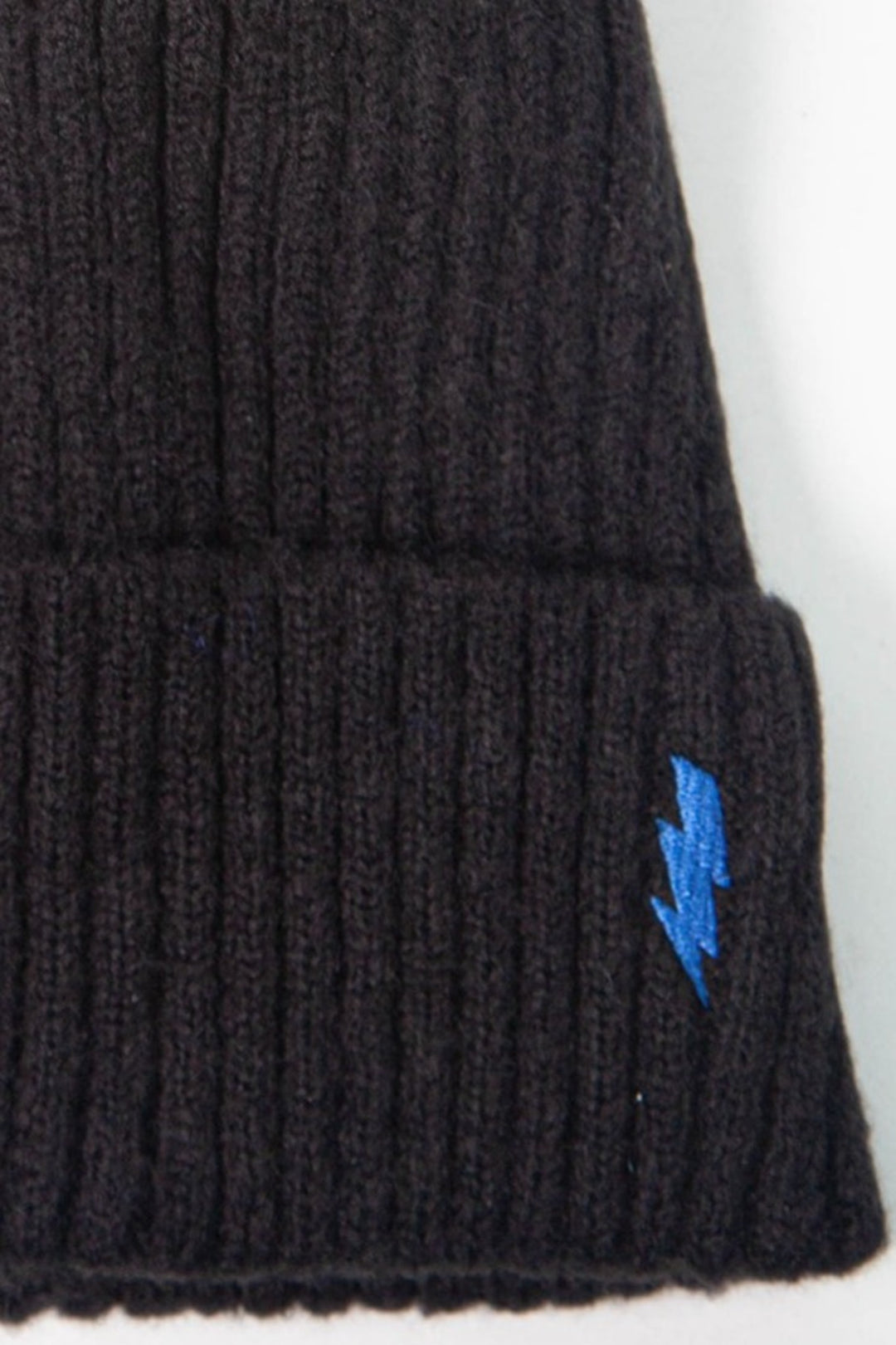 close up of the ribbed material and the embroidered lightning bolt on the beanie hat